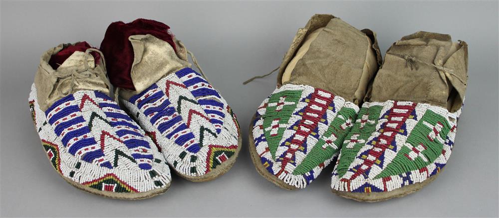 Appraisal: TWO PAIRS OF BEADED HIDE MOCCASINS sinew stitched hard soles