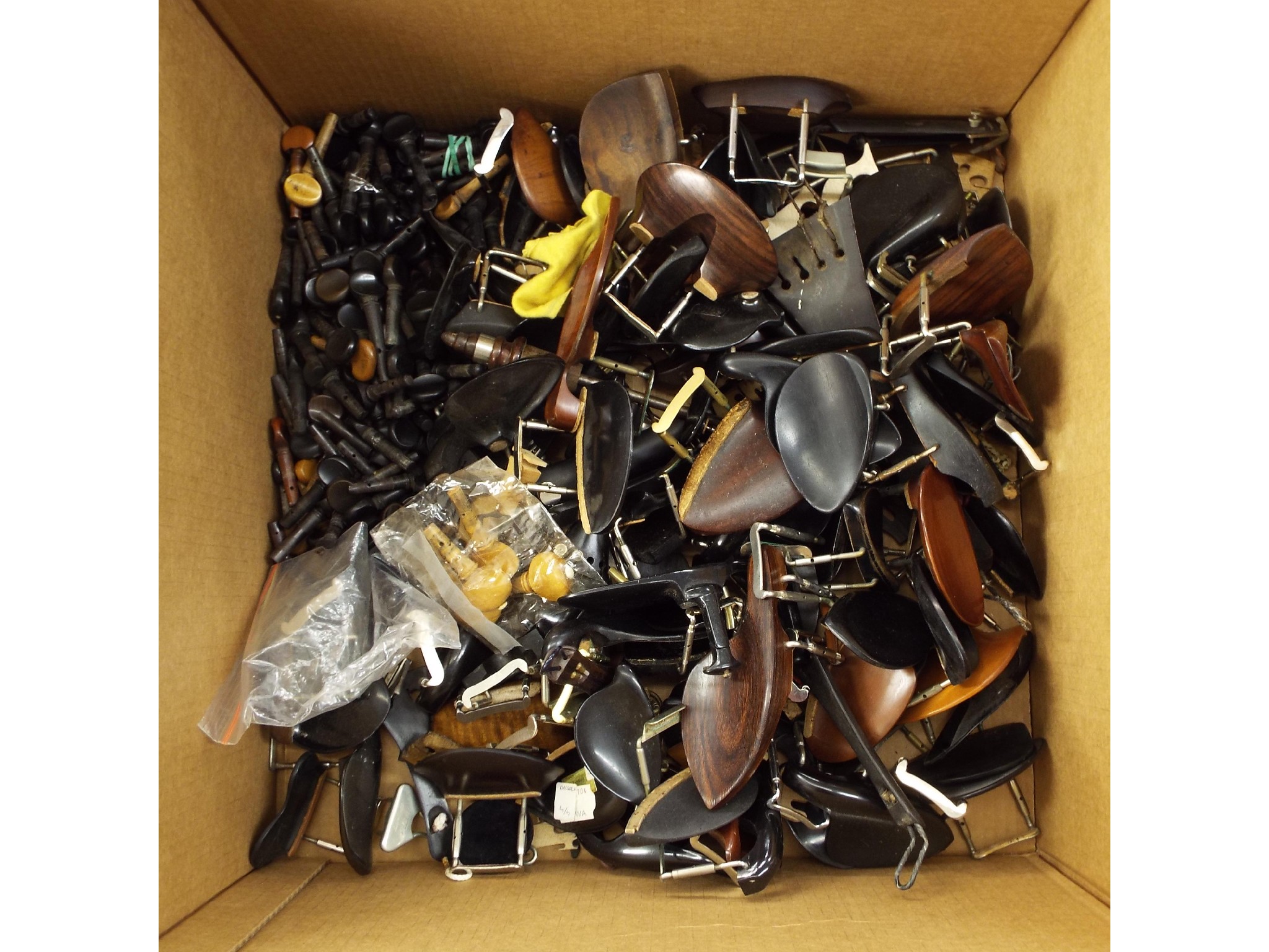 Appraisal: Box of various violin and violoncello fittings including chin rests