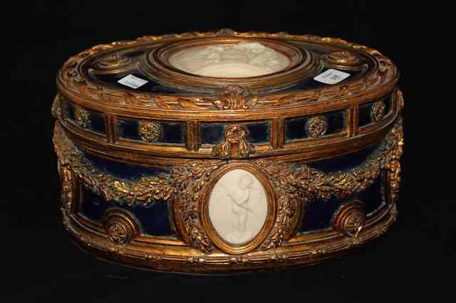 Appraisal: A POSSIBLY ITALIAN GILT AND BLUE OVAL CASKET with rosette