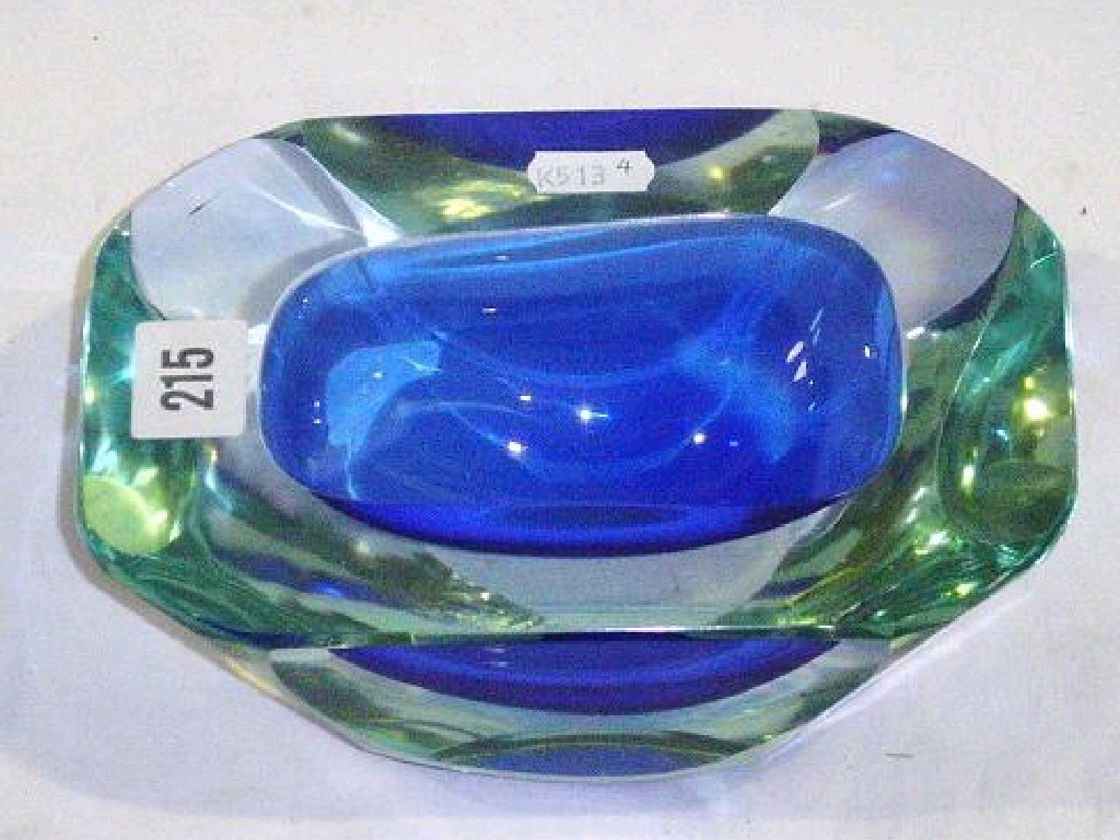 Appraisal: A heavy glass bowl of oblong form with blue and