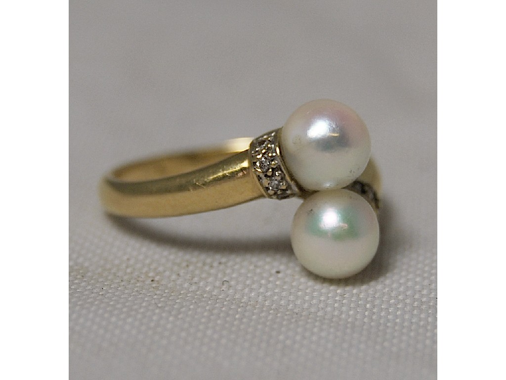 Appraisal: Pearl and diamond two-stone crossover ring yellow metal stamped