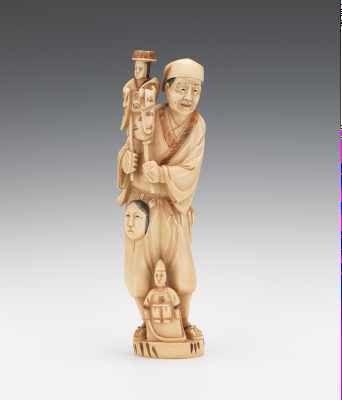 Appraisal: A Carved Ivory Figural of a Puppeteer Standing with a