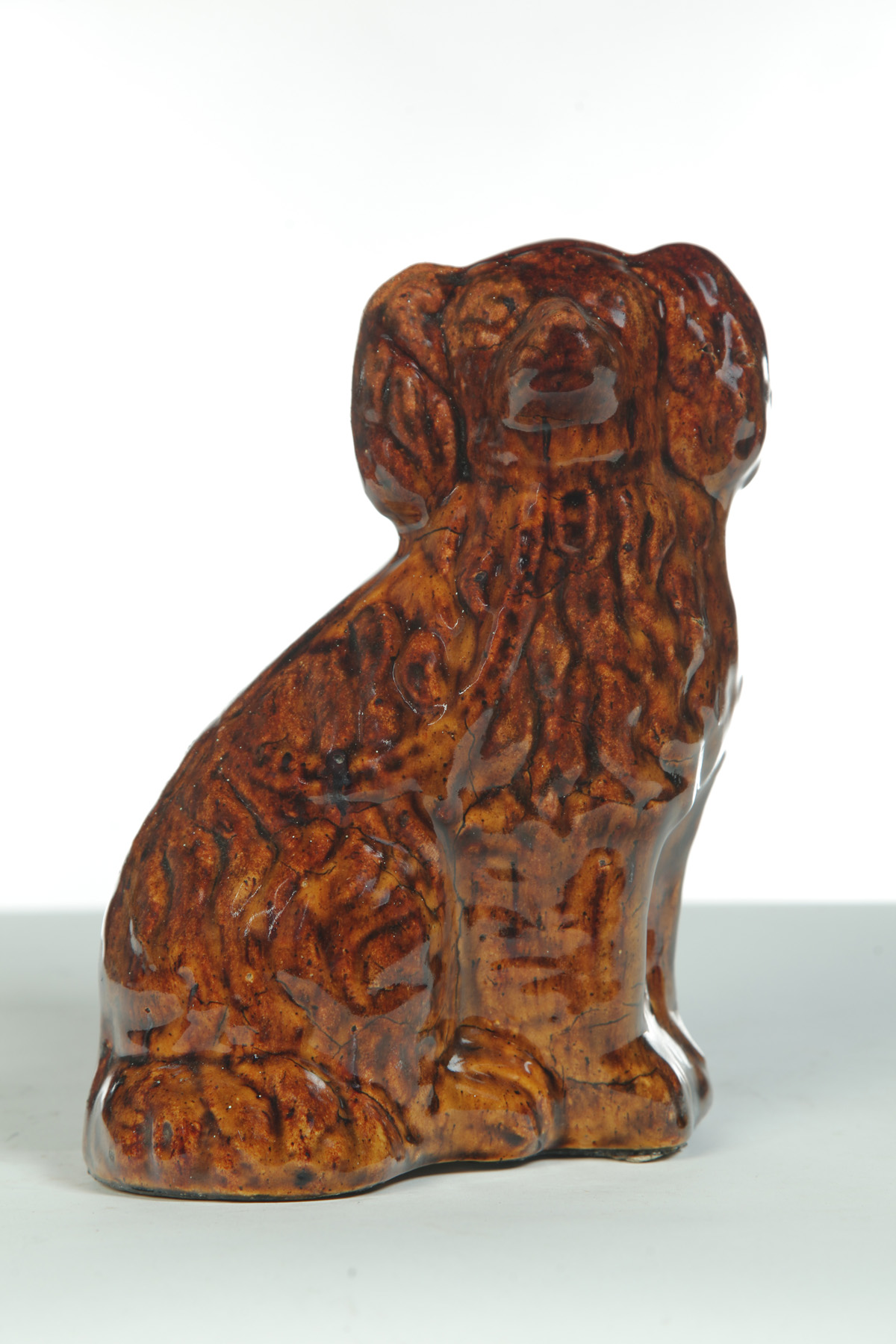 Appraisal: ROCKINGHAM SEATED SPANIEL England nd half- th century Yellowware with