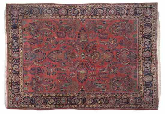 Appraisal: A Sarouk Wool Rug having a red reserve with floral