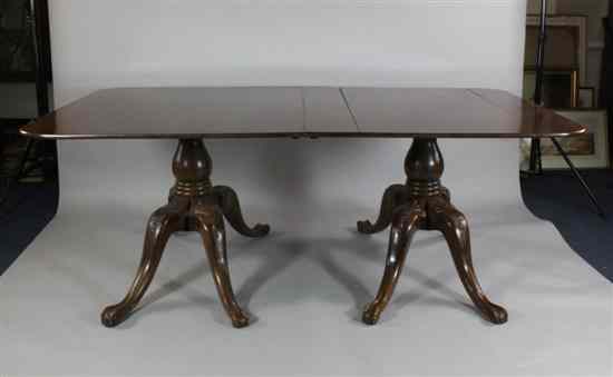 Appraisal: A Regency design mahogany twin pillar dining table on carved