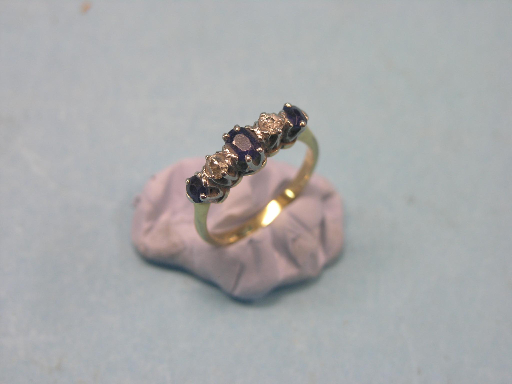 Appraisal: A yellow metal half-hoop ring two diamonds three sapphires claw