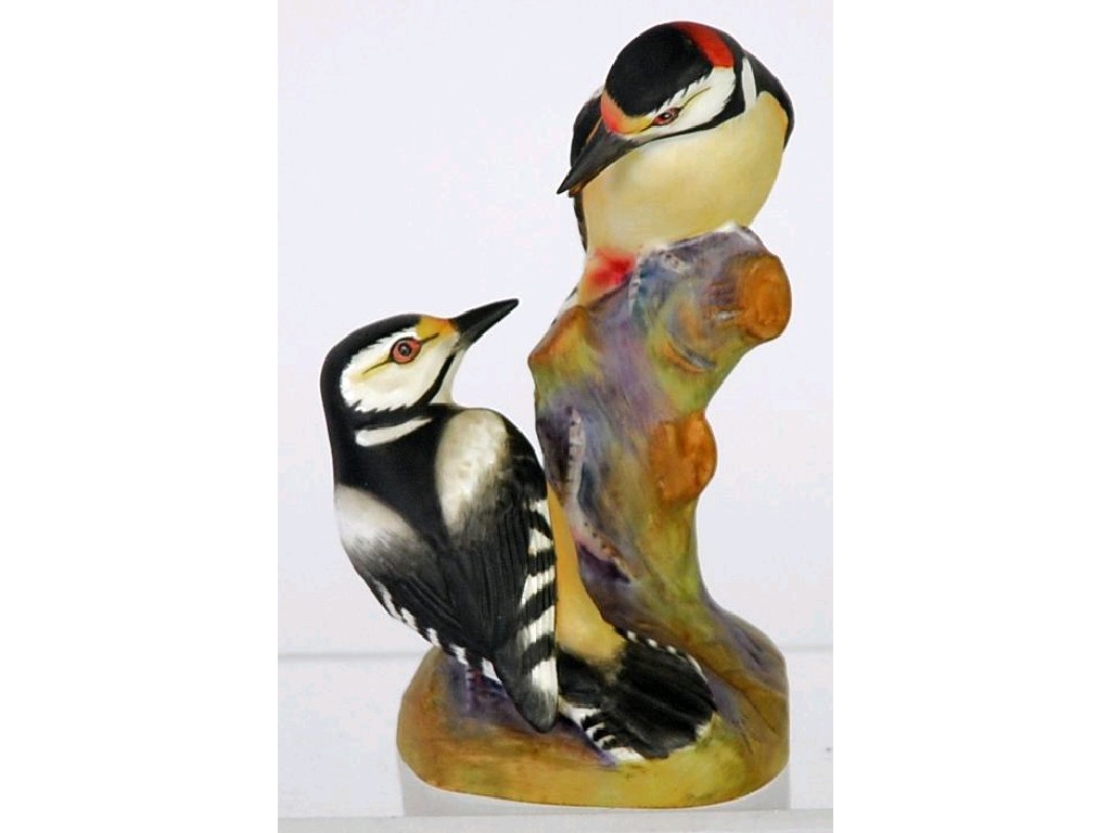 Appraisal: ROYAL WORCESTER BISQUE CHINA GROUP 'PIED WOODPECKERS' on a tree