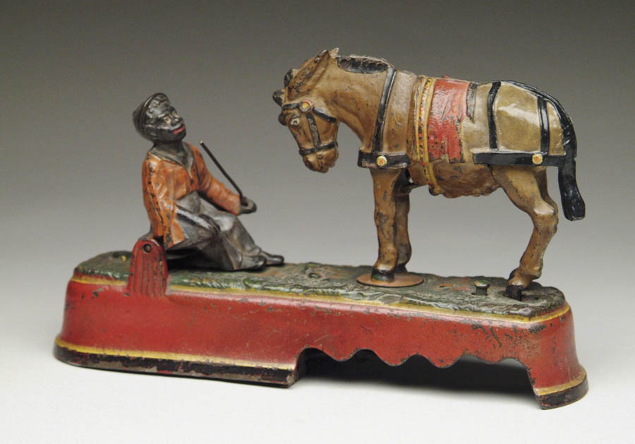 Appraisal: SPISE A MULE BOY SEATED ON BENCH MECHANICAL BANK Place