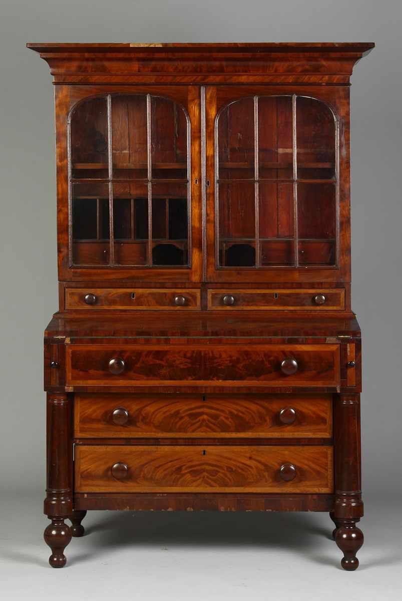 Appraisal: Empire Diminutive Secretary Figured mahogany Turned full columns Condition Some