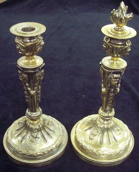 Appraisal: A pair of candlesticks of fluted taper column form decorated