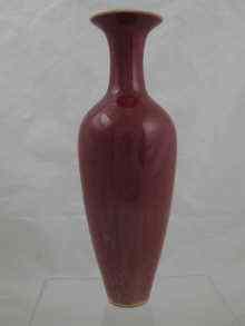 Appraisal: A tall red glazed Chinese vase with slim neck and