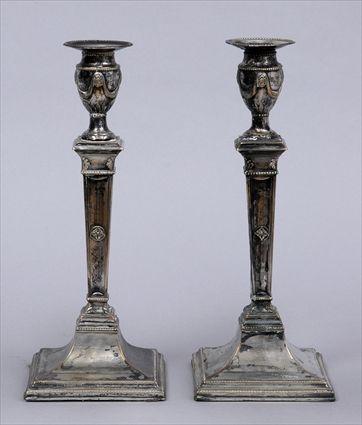 Appraisal: PAIR OF ENGLISH SILVER-PLATED COLUMN-FORM TABLE CANDLESTICKS Each angular tapered