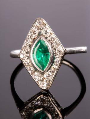 Appraisal: An emerald and diamond cluster ring the central marquise-shaped emerald