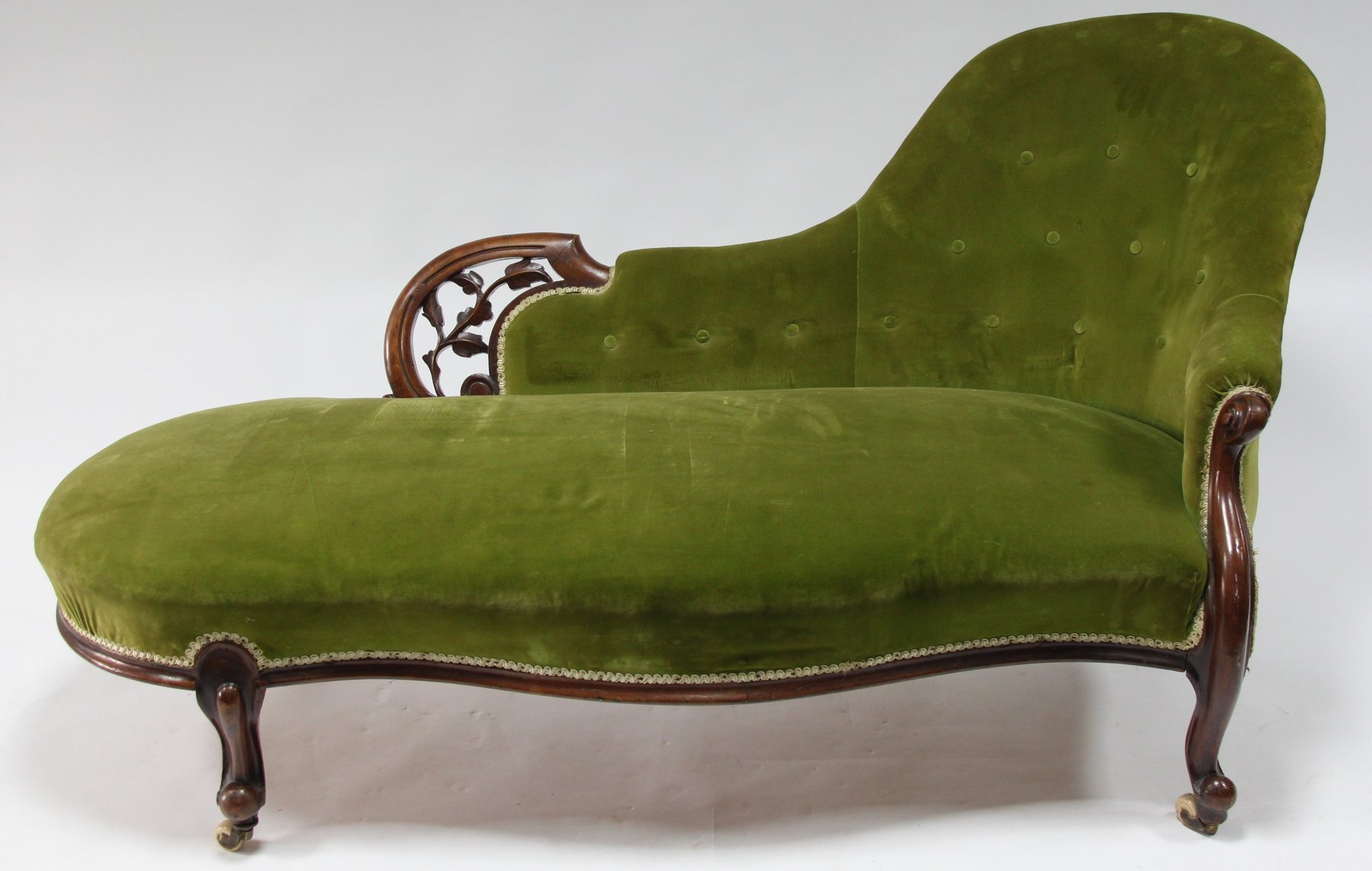 Appraisal: A Victorian carved walnut framed chaise longue on moulded cabriole