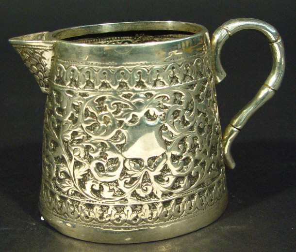 Appraisal: Middle Eastern silver metal cream jug cast in relief with