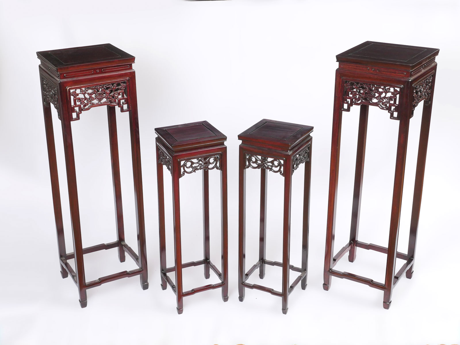 Appraisal: CARVED ROSEWOOD CHINESE PLANT STANDS Comprising tall stands having a