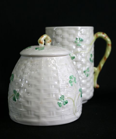 Appraisal: A Belleek honey pot and cover with matching beaker