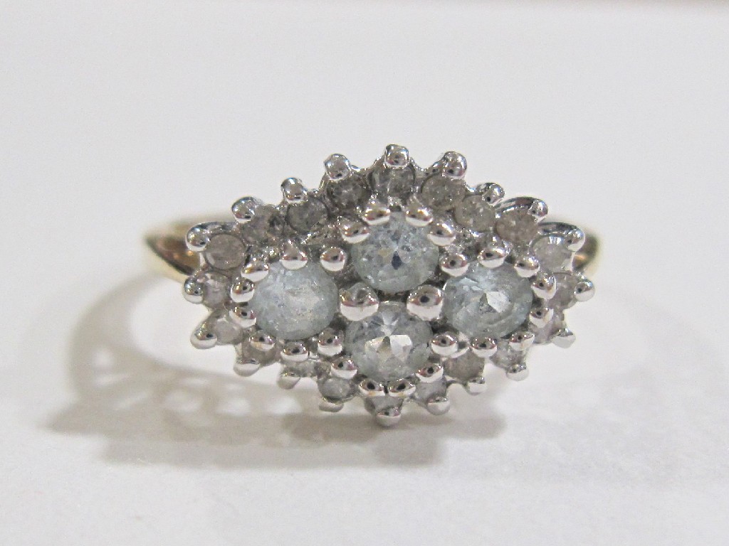 Appraisal: Nine carat gold blue topaz and diamond cluster ring