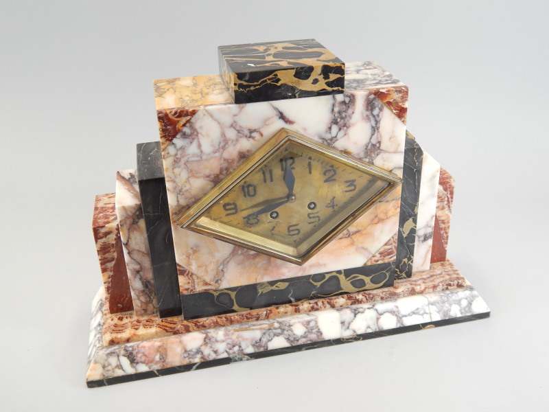 Appraisal: A French Art Deco period variegated marble mantel clock with