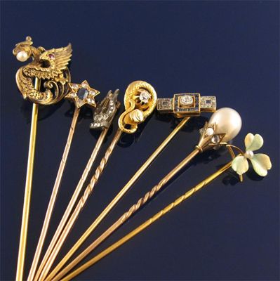 Appraisal: A shaded enamel gold stick pin in the form of