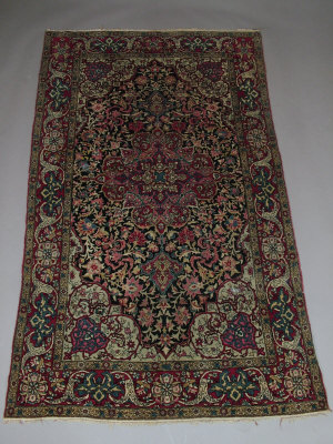 Appraisal: A Tabriz rug with pole medallion in an indigo field