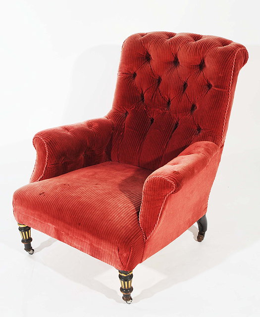 Appraisal: A VICTORIAN ARMCHAIR with red corderoy button upholstery and with