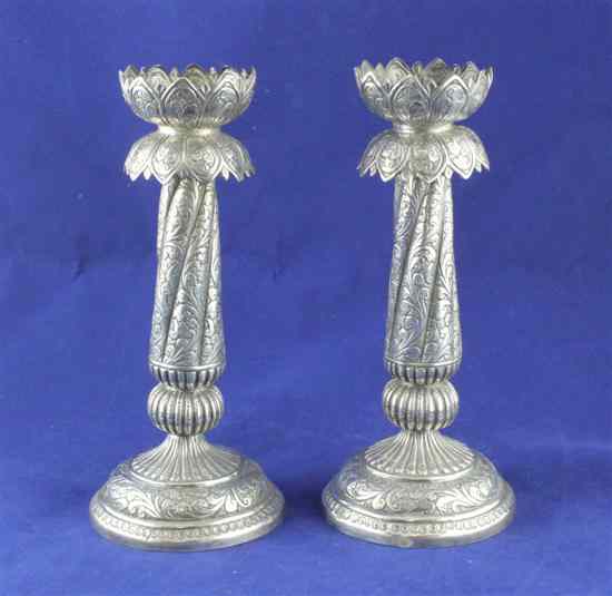 Appraisal: A pair of Indian white metal pricket candlesticks with spiral