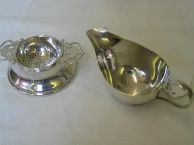 Appraisal: A TEA STRAINER ON STAND of circular form with pierced