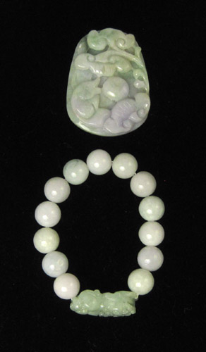 Appraisal: TWO ARTICLES OF JADE JEWELRY including a carved lavender and