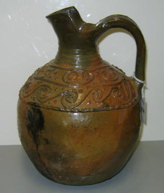 Appraisal: YELLOWWARE POTTERY JUG With amber brown glaze applied decoration and