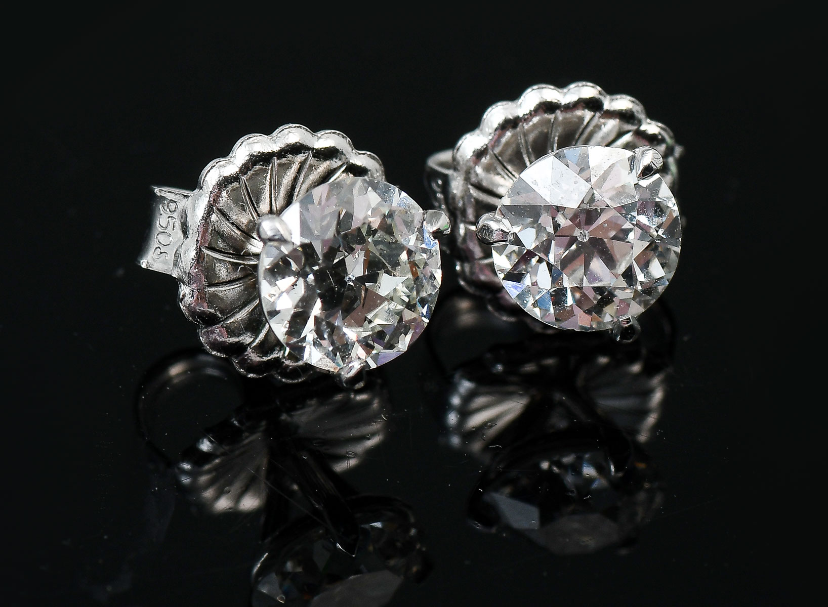 Appraisal: PLATINUM CTW DIAMOND STUDS Near colorless old Euro cut diamonds