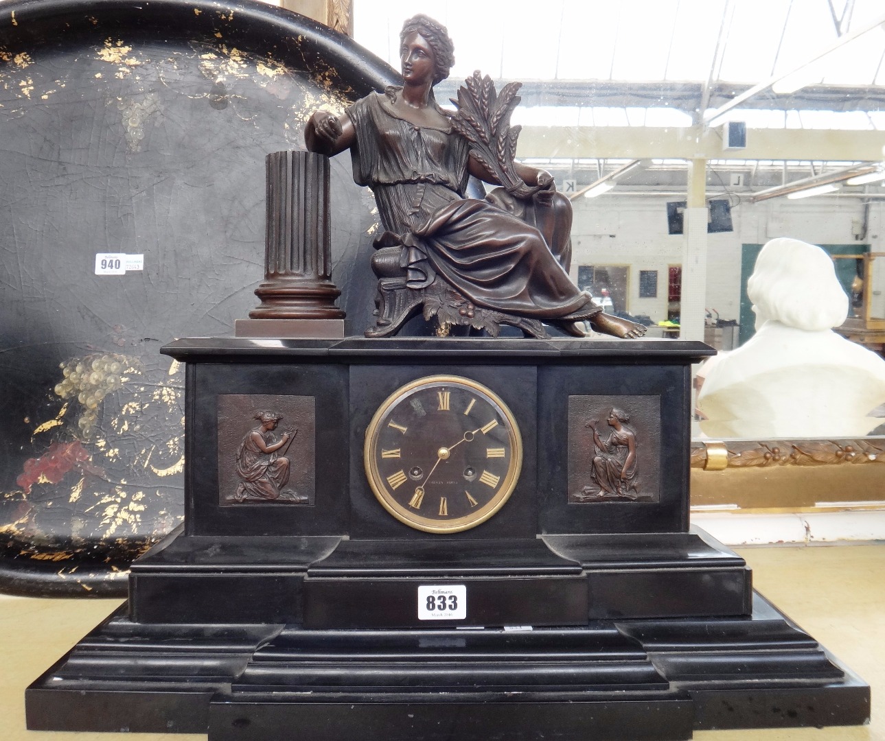 Appraisal: A Victorian black slate cased mantel clock with a bronze