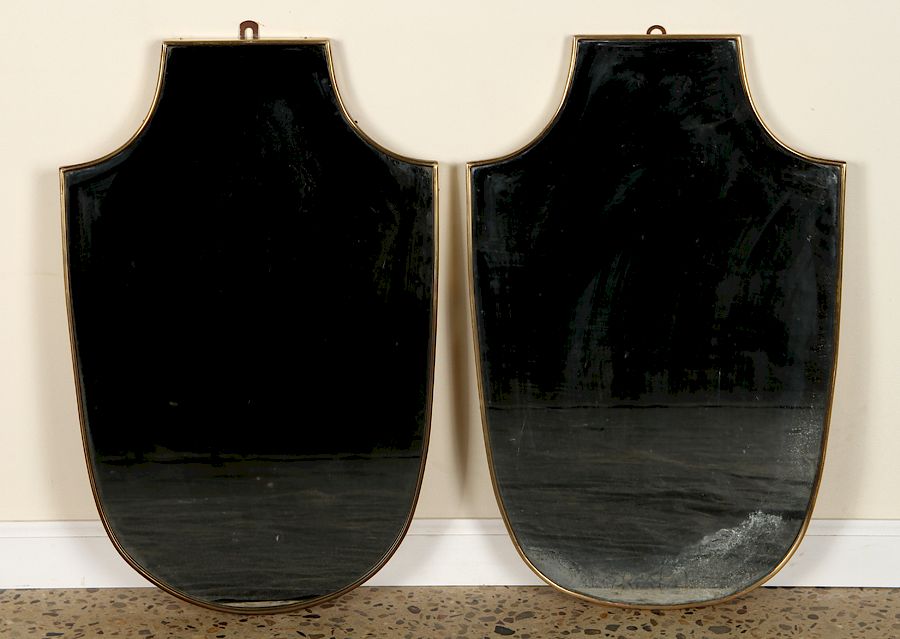 Appraisal: PAIR ITALIAN BRASS SHIELD FORM MIRRORS C A pair of