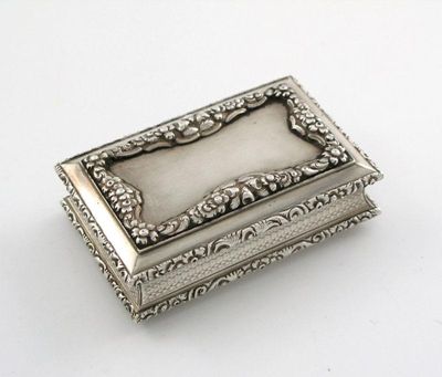 Appraisal: A Victorian snuff box with raised floral borders engine turned