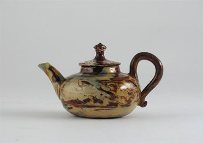 Appraisal: An agateware compressed circular teapot and cover Minor faults Mid