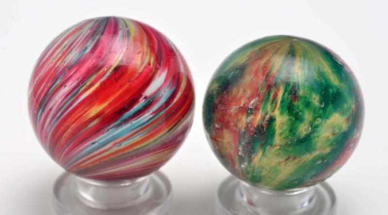 Appraisal: Lot of Onionskin Marbles Description The smaller marble is a