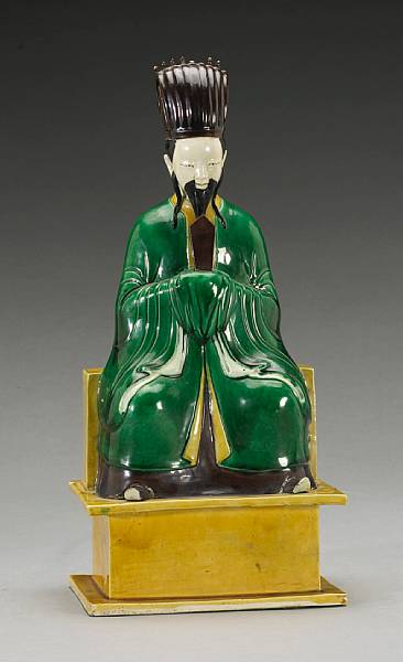 Appraisal: A 'spinach and egg' glazed seated soft paste figure of