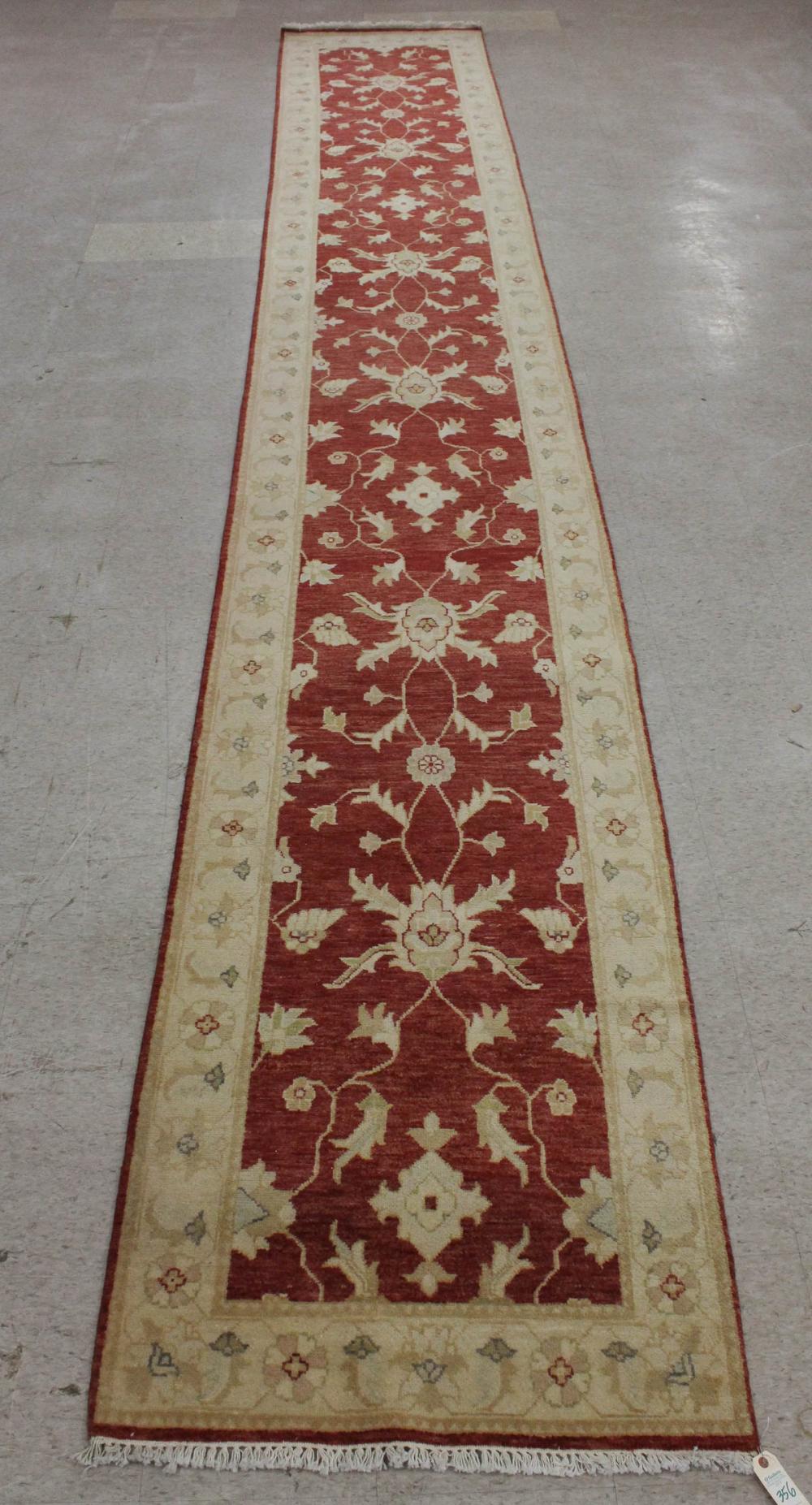 Appraisal: HAND KNOTTED ORIENTAL CORRIDOR RUG Pakistani-Persian overall scrolling floral design