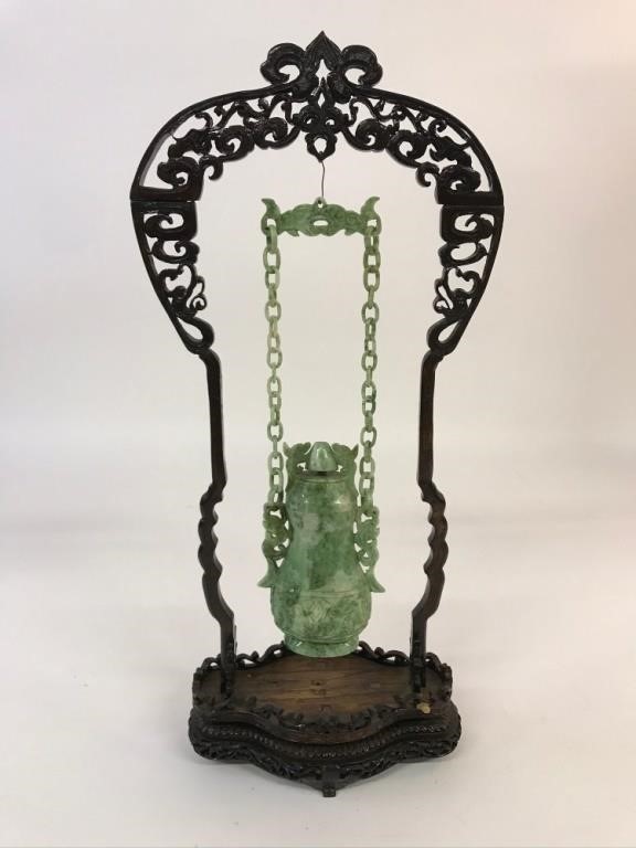 Appraisal: Carved jade hanging covered vase with delicate wood stand h