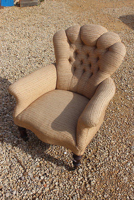 Appraisal: A VICTORIAN BUTTON UPHOLSTERED ARMCHAIR with scalloped back scroll arms