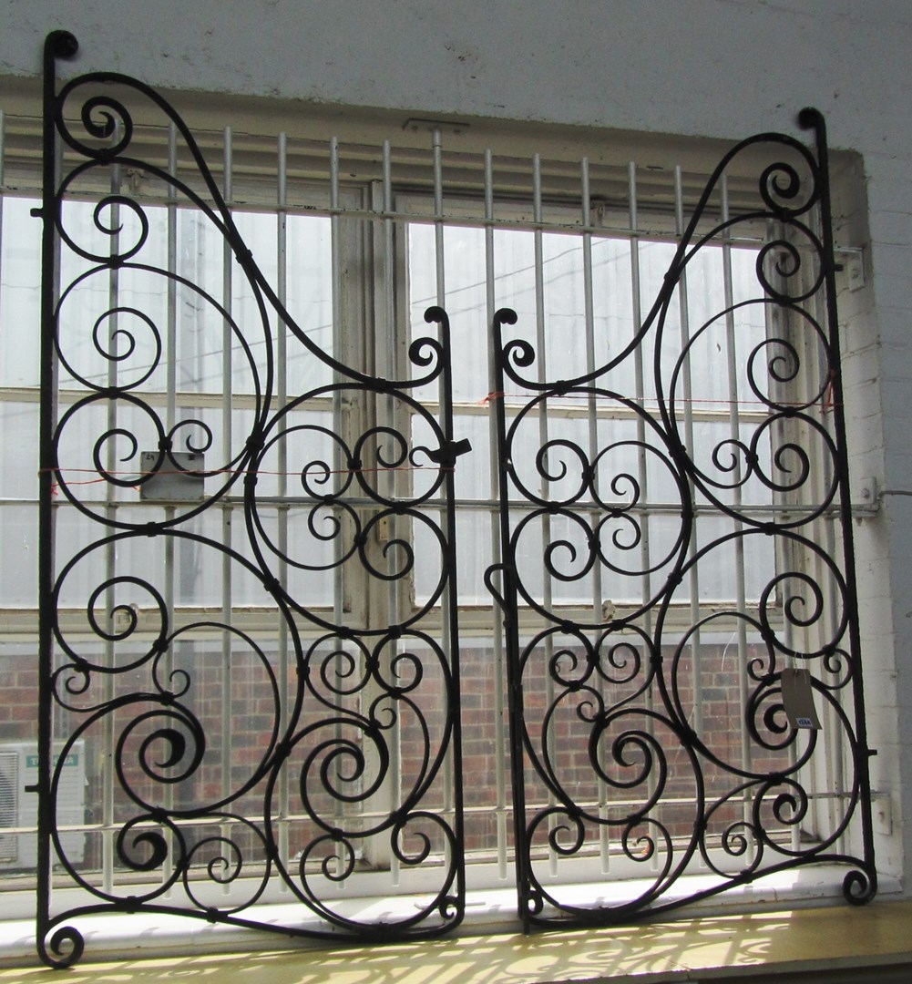 Appraisal: A pair of early th century black painted wrought iron