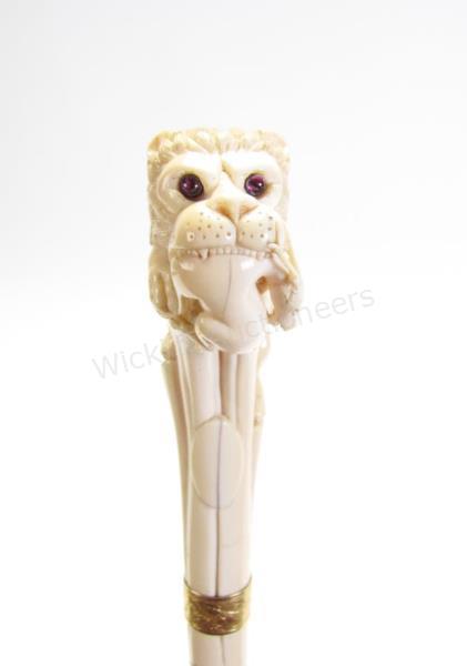 Appraisal: Lion and Prey Carved Cane ornately hand carved cane depicting