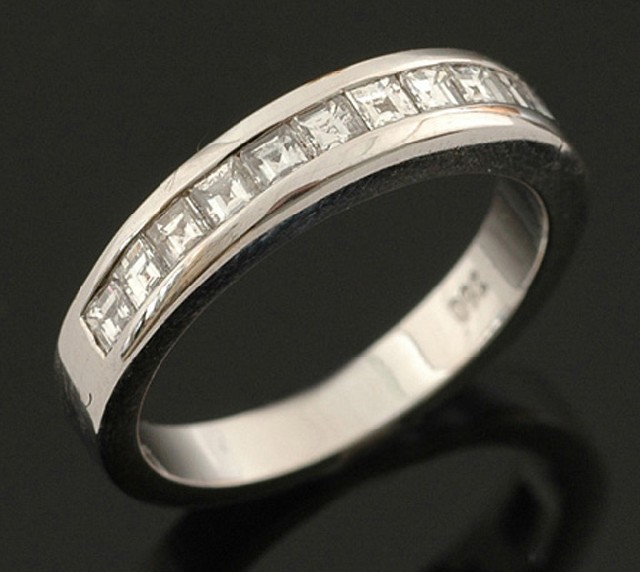 Appraisal: A diamond eternity ring Channel set with twelve asscher cut