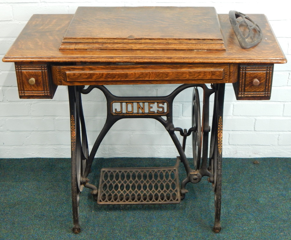 Appraisal: A Jones treadle sewing machine in an oak cabinet with