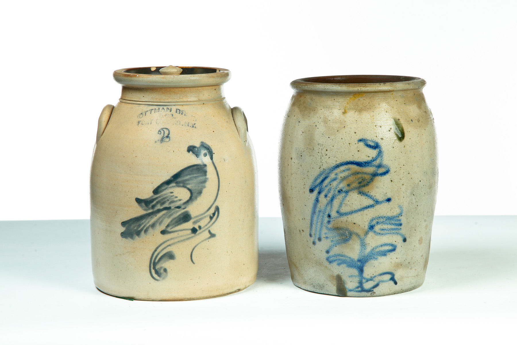 Appraisal: TWO PIECES OF STONEWARE WITH COBALT FREEHAND BIRD DECORATION American