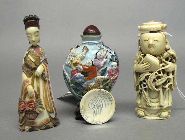 Appraisal: Three snuff bottles The first a molded porcelain bottle painted