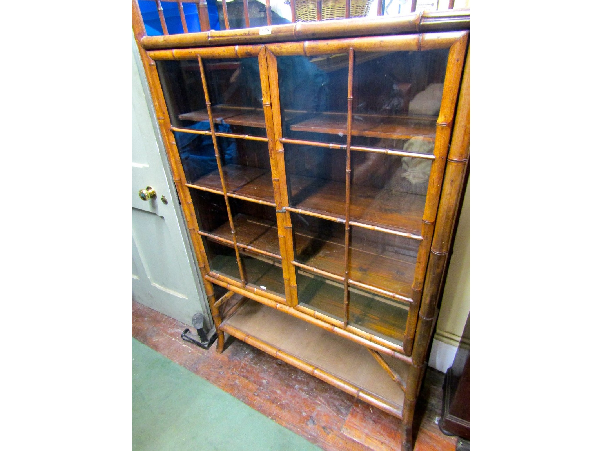 Appraisal: A late th century bamboo framed bookcase enclosed by two