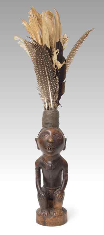 Appraisal: CARVED AFRICAN FIGURE '' TALL INCLUDES FEATHERSCONDITION Note may have