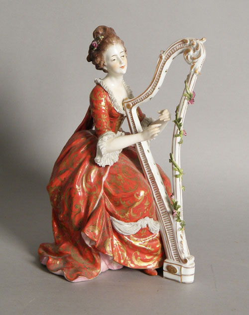 Appraisal: Painted porcelain figure of a woman playing the harp h