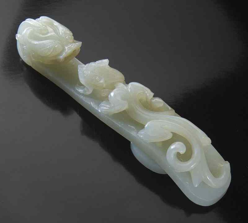 Appraisal: Chinese Qing carved white jade belt buckledepicting a dragon ''H